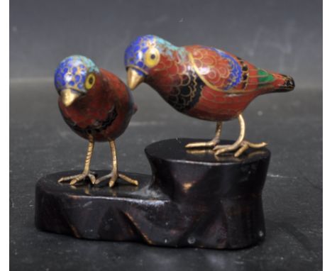 Two vintage 20th century Chinese / Oriental cloisonné enamel bird ornaments having red and gilt decoration raised on a black 