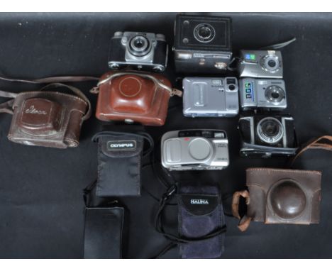 A collection of vintage 20th century camera equipment comprising of an Olympus Superzoom, Olympus Trip MD, Minolta Riva Zoom,