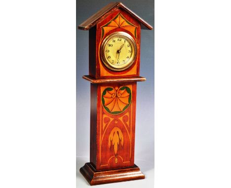 An Edwardian Art Nouveau cased miniature Grandfather Longcase clock having stencilled decoration with boxwood and stained gre