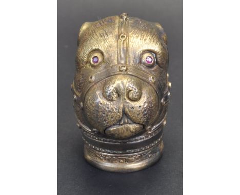 A vintage style large dogs head vesta case/ match case with ruby eyes and muzzle decoration. Having a hinged lid to the base.