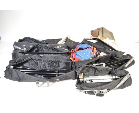 A large collection of studio lighting stands and tripods, largely Manfrotto complete with the travel cases. Including tripods