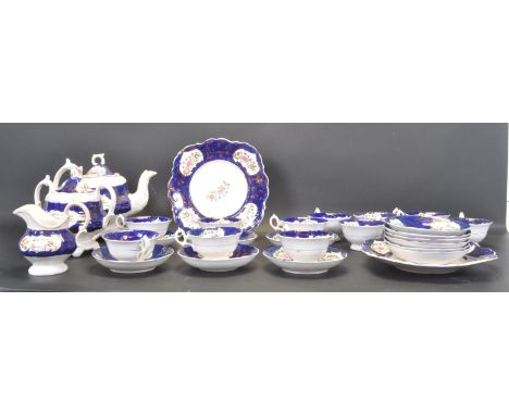 A Victorian 19th century ceramic tea service having a central blue border with gilt edging and polychrome floral decoration t