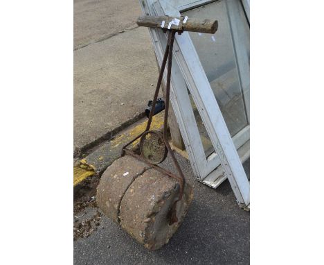 A cast iron and composite stone garden roller