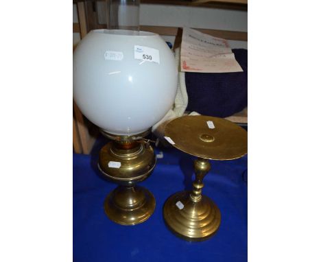 A brass oil lamp together with a similar stand