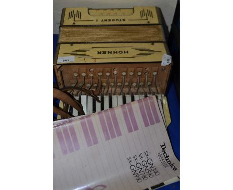 A Hohner accordion (a/f) together with sheet music