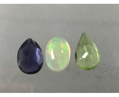 **THREE CERTIFICATED UNMOUNTED GEMSTONES,including a 0.70 carat iolite, 0.74 carat peridot and a 0.66 carat fire opal (3)