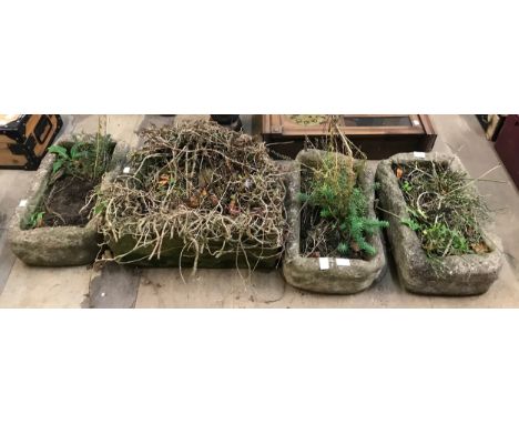 A D-shaped concrete garden planter and three others 