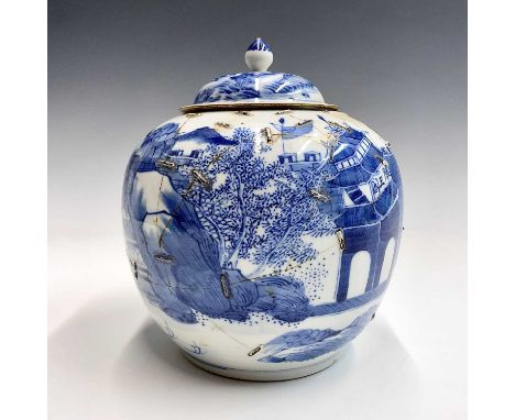 A Chinese blue and white porcelain jar and cover, late 19th century, decorated with a river scene including buildings and fig