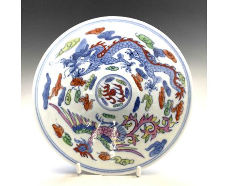 A Chinese wucai dragon and phoenix porcelain bowl, circa 1900, six character Kangxi mark, height 5.7cm, diameter 14.8cm.