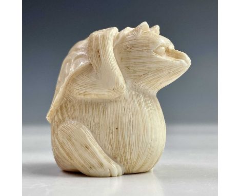 A Japanese ivory netsuke of a possum beneath a leaf, Meiji period, signed, height 4cm, width 3cm, depth 4cm.