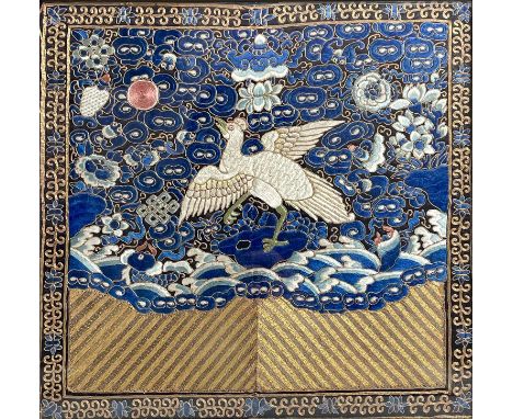 A Chinese Mandarin silk embroidered rank badge, mid 19th century, the long-tailed, multi-coloured bird facing the magenta sun