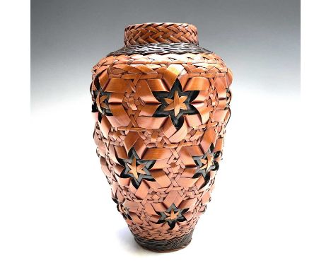 A Japanese Ikebana vase, (flower arrangement) 20th century, of woven bamboo with ceramic interior, height 24.5cm.