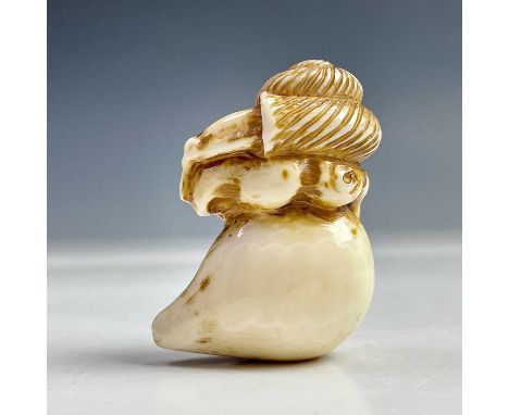 A Japanese ivory netsuke of a snail on a persimmon, Meiji period, signed, height 4.5cm, width 3cm.  