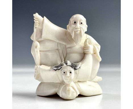 A Japanese ivory netsuke group, early 20th century, signed, height 5.5cm, width 5cm.