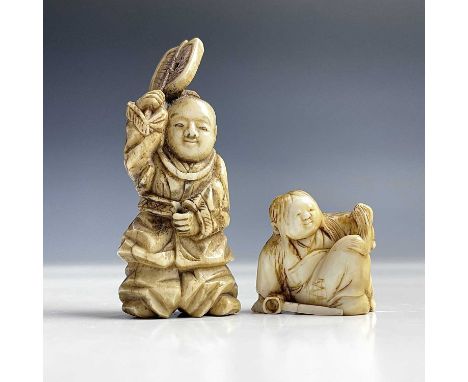 A small Japanese ivory netsuke of a seated boy, Meiji period, height 2.5cm and a Japanese okimono of a standing figure with a