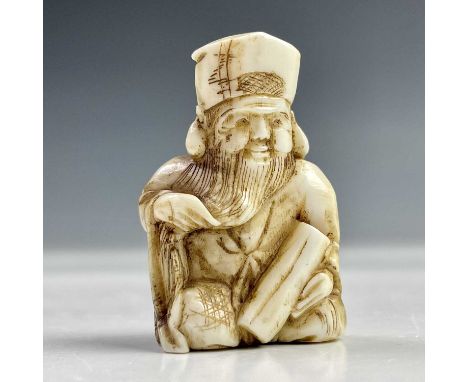 A Japanese ivory netsuke of a seated bearded man, Meiji period, signed, height 3.8cm, width 2.5cm.