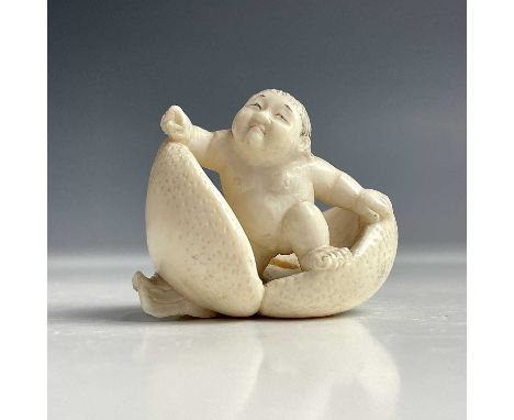 A Japanese ivory netsuke of Momotaro the peach boy, Meiji period, height 4cm, width 4.5cm.