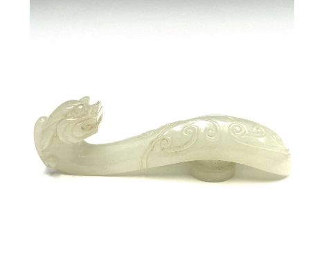 A Chinese jade belt hook, mid 20th century, of typical form, with a dragon's head and scroll carved body, length 7cm.Conditio