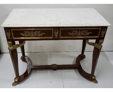 French Empire style Console Table, the rectangular white marble top over brass mounted aprons and winged classic figures at t