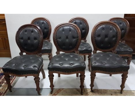 Set of 6 Button Back Victorian heavy mahogany dining chairs on turned front legs with casters, with black leatherette buttone