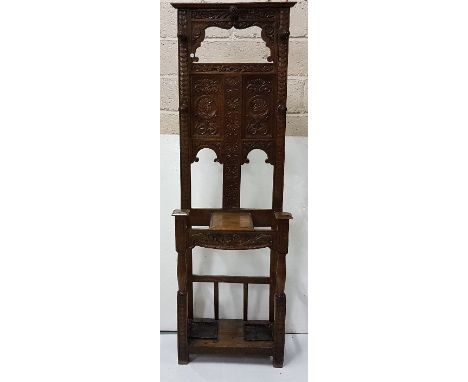 Early 20th C carved oak narrow hallstand, with Roman figures and 5 turned coat hangers, 2 stick compartments, 24”w x 74”h