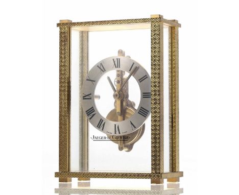 Jaeger LeCoultre small mystery desk clock timepiece, the 2.25" silvered chapter ring enclosing a skeletonised centre with in-