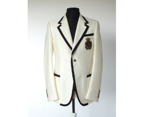 A Gucci jacket, cream with black edging detail, black and gold Gucci crest embroidered badge to breast pocket, patch pockets,