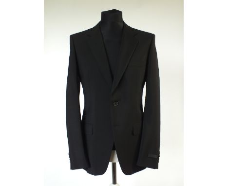 A Prada suit, black, swing ticket attached, single vent, Italian size 52R, 60% mohair, 40% wool, flat front to trousers, butt