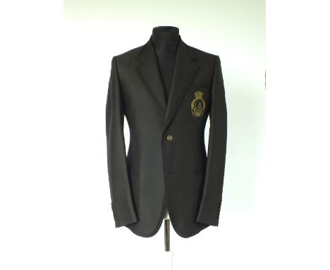 A Gucci jacket, black with black grosgrain edging details, black and gold Gucci embroidered crest badge to breast pocket, pat