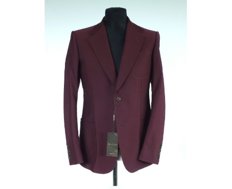 A Gucci jacket, brand new with Gucci swing ticket, burgundy, patch pockets, single vent, top stitching detail, lined, Italian