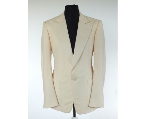 A Gucci dinner jacket, cream, grosgrain lower lapel, patch pockets, lined, double vent, Italian size 54R, 100% wool