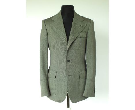 A Gucci jacket, grey, patch pockets with inverted pleat and flap, belt detail to back, single vent, lined, Italian size 50R, 