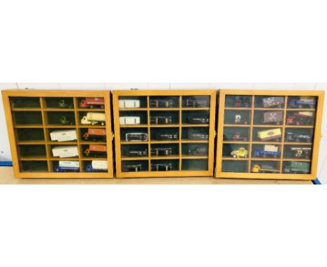 Wall mounted display cases containing 1/76 scale die cast model cars