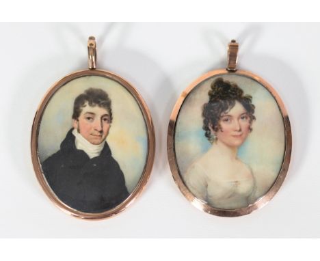 TWO REGENCY PERIOD PORTRAIT MINIATURES on ivory; one as a lady in Empire line dress, the other of a gentleman in stock collar