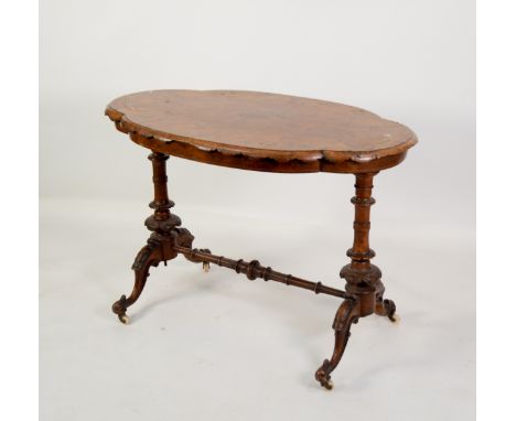 MID-VICTORIAN WALNUT END-STANDARD TABLE, the oval quatrefoil figured and inlaid top with ovolo scalloped edge, raised upon tu