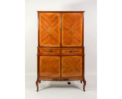EPSTEIN BROS: Mid to late 20th century walnut marquetry cocktail cabinet with elevated glass cupboard surmounting a two-door 