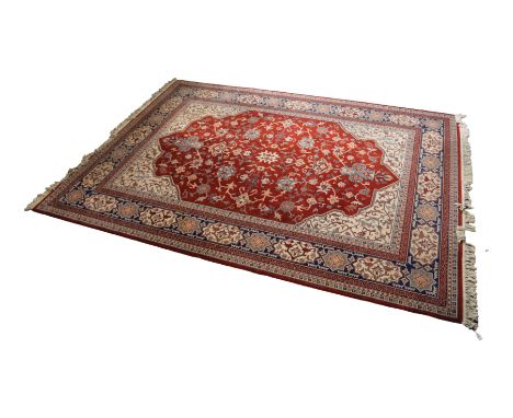 MACHINE WOVEN WOOL CARPET OF PERSIAN DESIGN, with all-over Herati design on a wine red field, with off-white spandrels, large