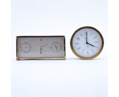 Two Brass Clocks. A Tiffany & Co. round quartz clock, inscribed "To Jay From Normie 12-11-81"; a Saks brass and leather Swiss