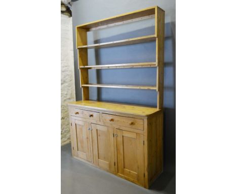 A Pine Dresser, the shelf back above two drawers, three cupboard doors flanked by stiles, 150cm wide, 49cm deep, 217cm high 