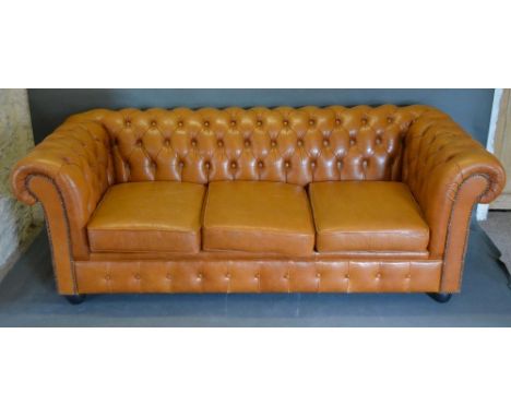 A Tan Leather Buttoned Chesterfield Sofa with low turned feet, 195cm wide, 84cm deep 