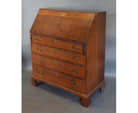 A George III Oak Bureau, the fall front enclosing a fitted interior above four long drawers with brass swan-neck handles and 