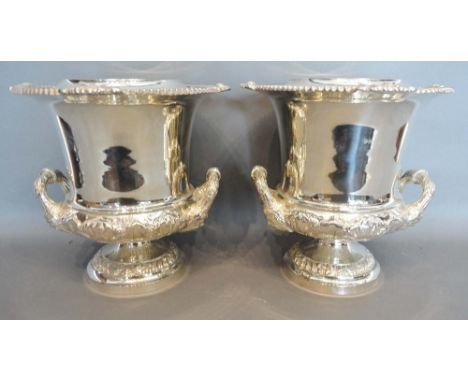 A Pair of Silver Plated Two Handled Wine Coolers with silver plated liners and circular pedestal bases, 26cm tall 