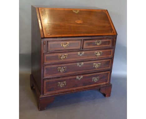 A George III Mahogany Line and Shell Inlaid Bureau, the fall front enclosing a fitted interior above two short and three long