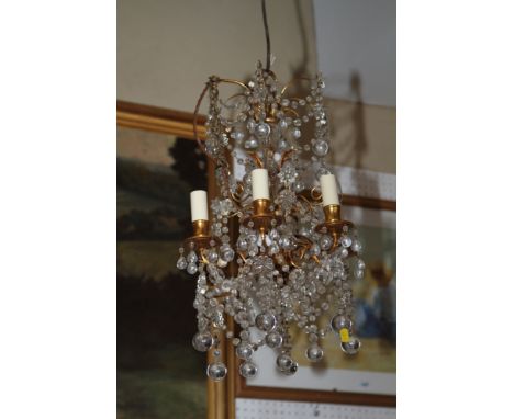 An early 20th century five-light gilt metal chandelier with rain drop pendants, 20" high 