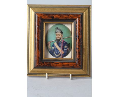A 19th century miniature portrait of a Sikh warrior with a matchlock, 3" x 2 1/4", in grained and gilt frame