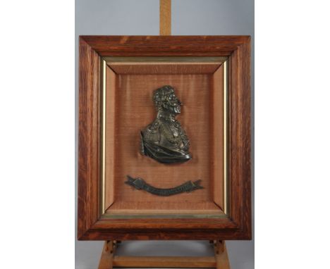 A 19th century bronzed relief plaque bust of the Duke of Wellington, in wooden strip frame, and a 19th century gilt metal pla