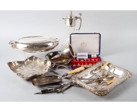 A silver plated two-handled tray, a cut glass claret jug with plated mounts, a plated entree dish and cover, various plated f