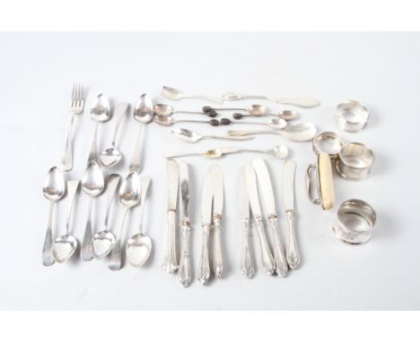 A selection of silver flatware and napkin rings, a silver mounted nail buffer and eight silver handled butter knives 