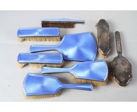 A silver and blue guilloche enamel six-piece dressing table set and two other silver backed dressing table brushes 