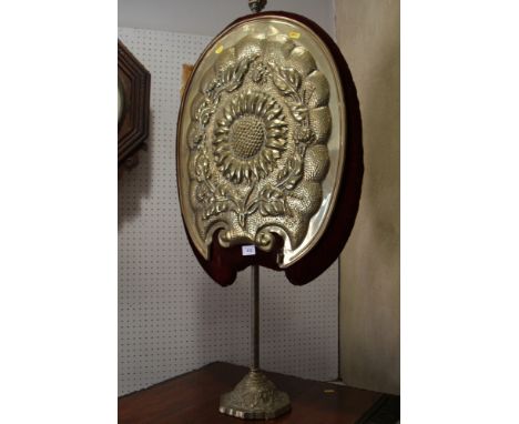 A late 19th century Arts &amp; Crafts embossed brass firescreen with sunflower panel, on weighted base, panel, 25" high x 22"